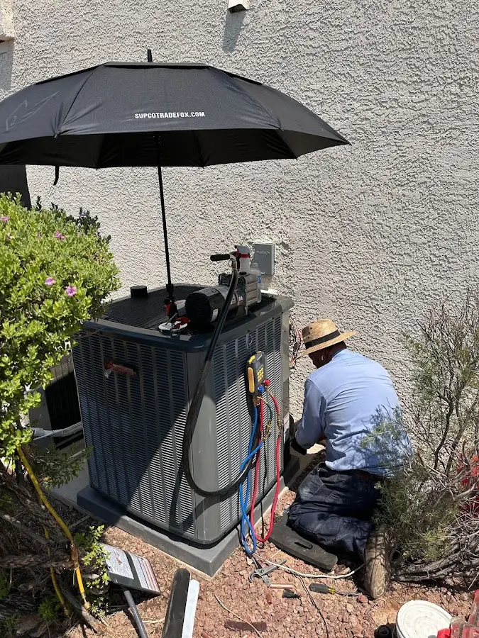 HVAC technician performing outdoor AC maintenance in Middleton